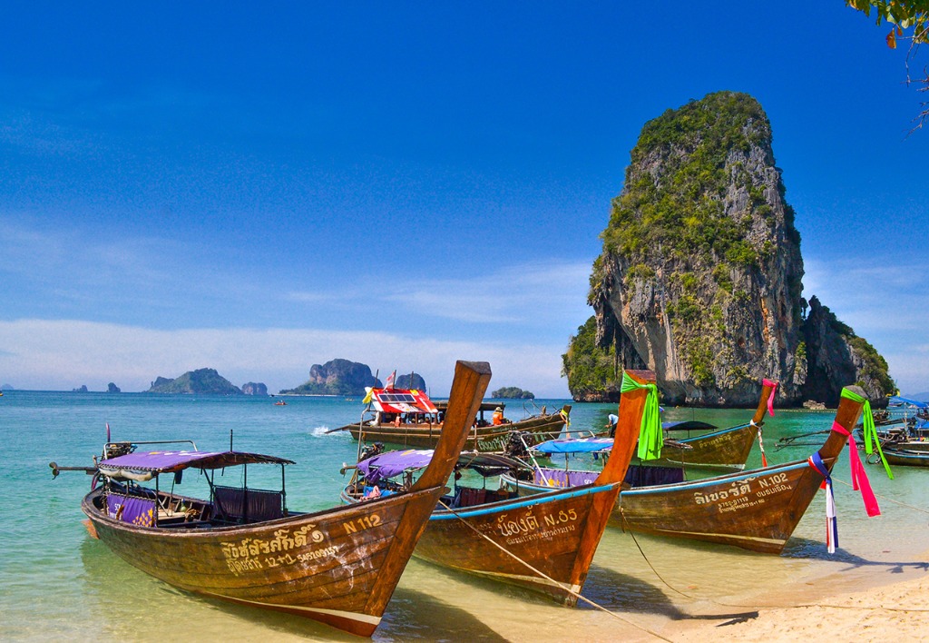 Traditional wooden boats anchored in crystal-clear turquoise island waters